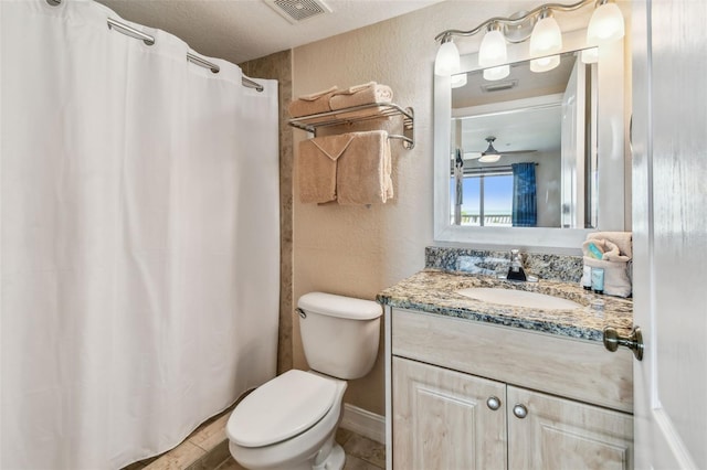 11605 Gulf Blvd Unit 506, Saint Petersburg, FL 33706 - full bath with vanity, toilet, a textured wall, a shower with curtain, and tile patterned floors