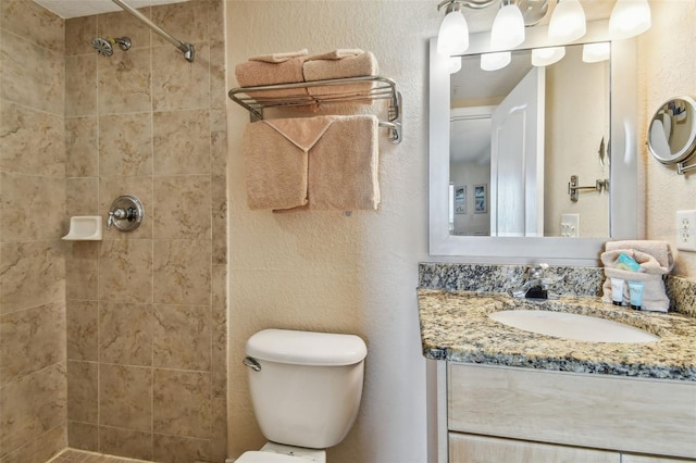 11605 Gulf Blvd Unit 506, Saint Petersburg, FL 33706 - full bath featuring vanity, toilet, a tile shower, and a textured wall