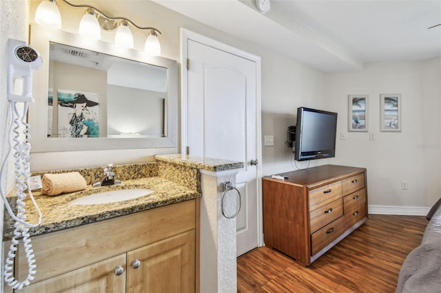 11605 Gulf Blvd Unit 506, Saint Petersburg, FL 33706 - bathroom featuring wood finished floors, vanity, and baseboards