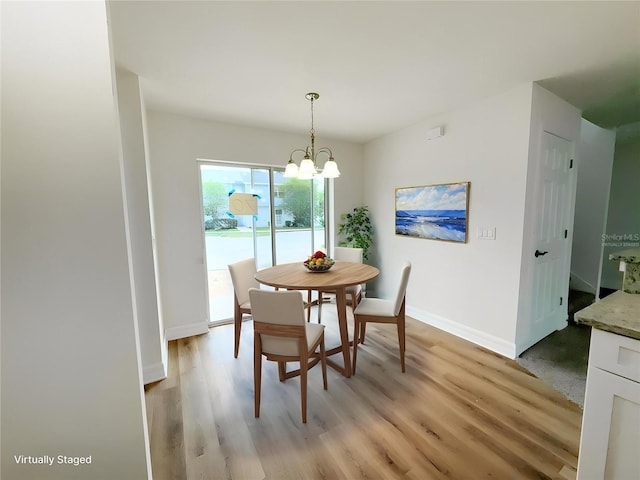 222 Carpenters Way Unit 71, Lakeland, FL 33805 - dining room featuring a chandelier, light wood-style floors, and baseboards