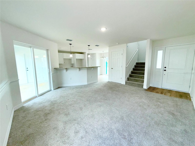 222 Carpenters Way Unit 71, Lakeland, FL 33805 - unfurnished living room with carpet flooring, stairs, baseboards, and recessed lighting