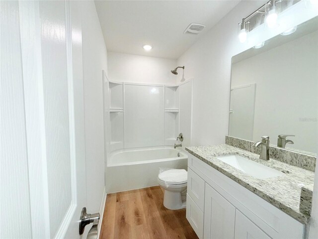 222 Carpenters Way Unit 71, Lakeland, FL 33805 - full bathroom with toilet, vanity, wood finished floors, and shower / washtub combination