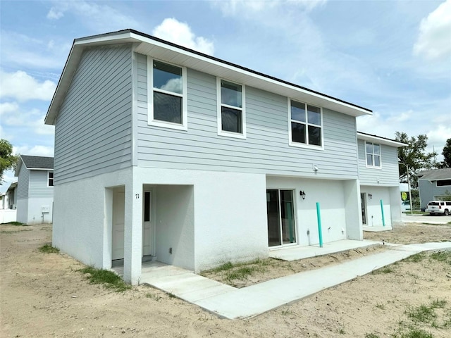 222 Carpenters Way Unit 71, Lakeland, FL 33805 - rear view of house featuring stucco siding