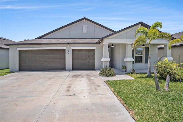 146 Rain Berry Ave, Ruskin, FL 33570 - view of front of house featuring driveway, a garage, a front yard, and stucco siding