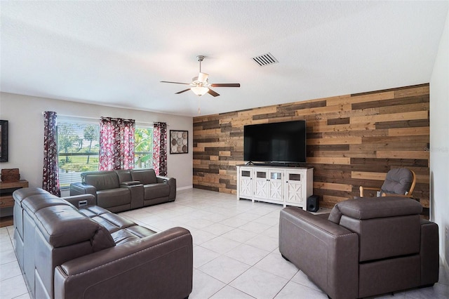146 Rain Berry Ave, Ruskin, FL 33570 - living room featuring wooden walls, an accent wall, ceiling fan, and light tile patterned floors