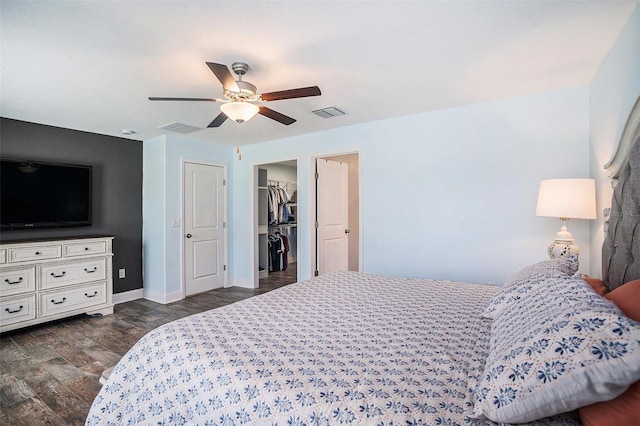 146 Rain Berry Ave, Ruskin, FL 33570 - bedroom featuring dark wood-style floors, a ceiling fan, and a spacious closet
