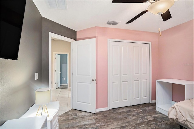 146 Rain Berry Ave, Ruskin, FL 33570 - bedroom featuring a closet, wood finished floors, and a ceiling fan
