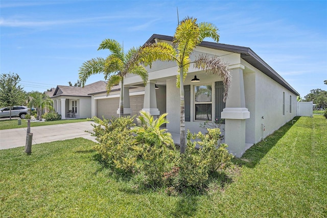 146 Rain Berry Ave, Ruskin, FL 33570 - view of front of house with concrete driveway, a front yard, stucco siding, and a garage