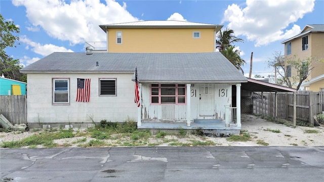 131 92nd Ave, Treasure Island, FL 33706 - back of property with driveway, covered porch, and a carport