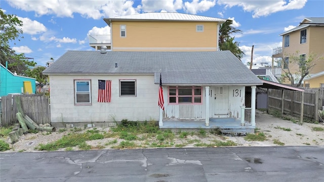 131 92nd Ave, Treasure Island, FL 33706 - rear view of property with a porch and roof with shingles