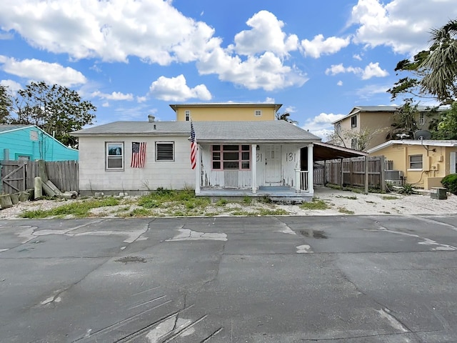 131 92nd Ave, Treasure Island, FL 33706 - view of front of house featuring covered porch and a carport