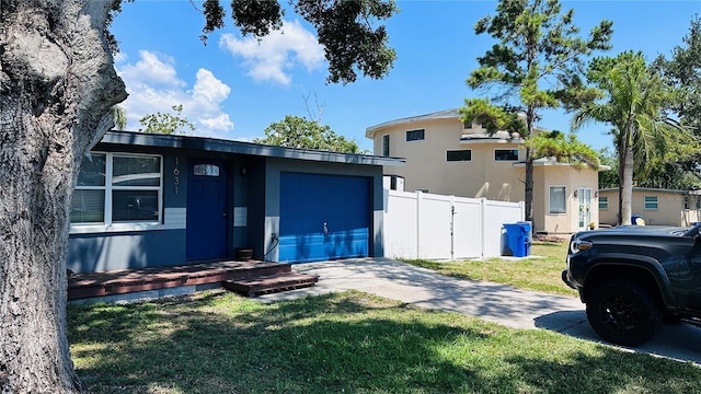 1631 St Mary Dr, Dunedin, FL 34698 - view of front facade featuring concrete driveway, stucco siding, and a garage