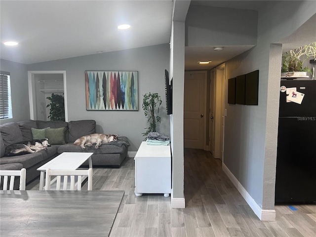 1631 St Mary Dr, Dunedin, FL 34698 - living room featuring baseboards, light wood-type flooring, vaulted ceiling, and recessed lighting