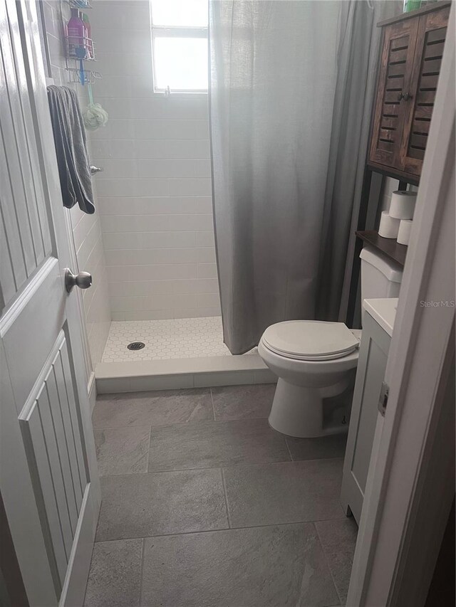 1631 St Mary Dr, Dunedin, FL 34698 - bathroom featuring toilet, vanity, and a stall shower