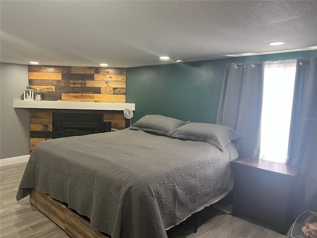 1631 St Mary Dr, Dunedin, FL 34698 - bedroom featuring wood finished floors, a textured wall, a textured ceiling, and recessed lighting