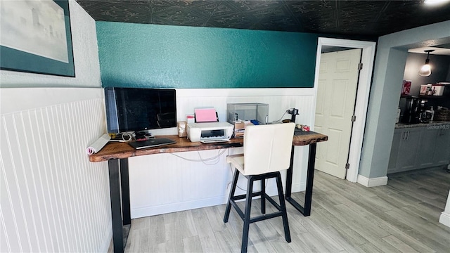 1631 St Mary Dr, Dunedin, FL 34698 - office area featuring light wood finished floors, an ornate ceiling, and a wainscoted wall