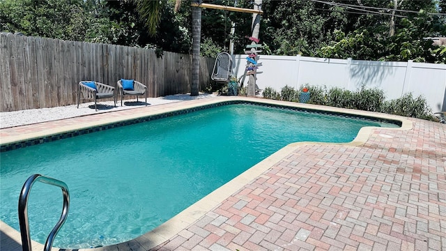 1631 St Mary Dr, Dunedin, FL 34698 - view of swimming pool with a fenced backyard and a patio