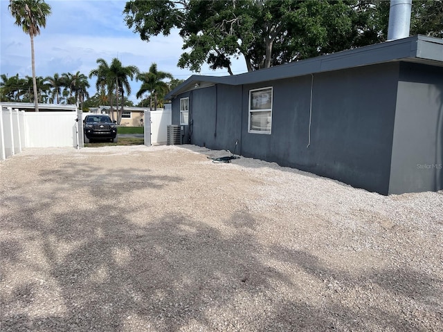 1631 St Mary Dr, Dunedin, FL 34698 - view of side of property featuring central air condition unit and driveway