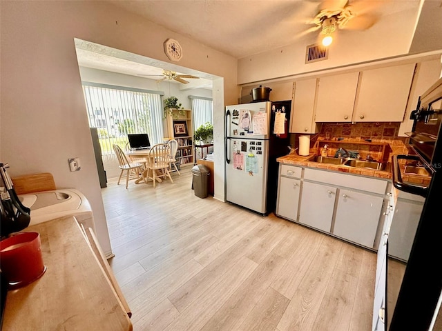 2434 Australia Way E Unit 38, Clearwater, FL 33763 - kitchen featuring ceiling fan, freestanding refrigerator, light wood-style floors, and a sink