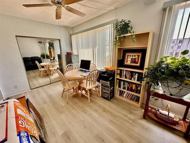 2434 Australia Way E Unit 38, Clearwater, FL 33763 - dining area featuring wood finished floors, a ceiling fan, a textured ceiling, and a textured wall