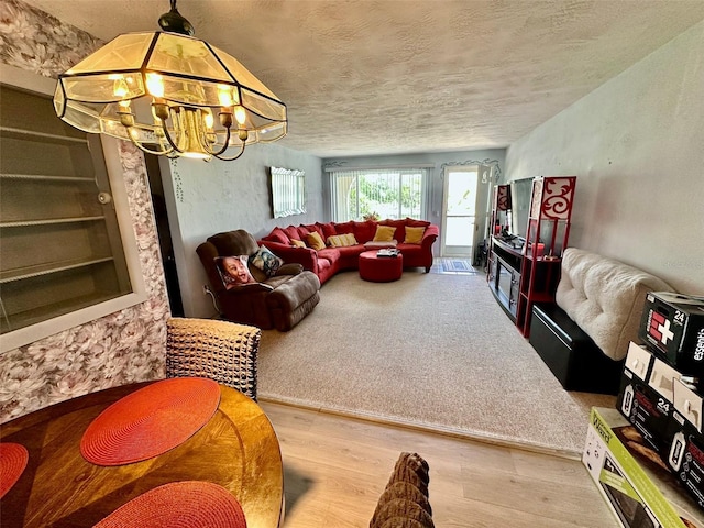 2434 Australia Way E Unit 38, Clearwater, FL 33763 - living room featuring wood finished floors, a chandelier, and a textured ceiling