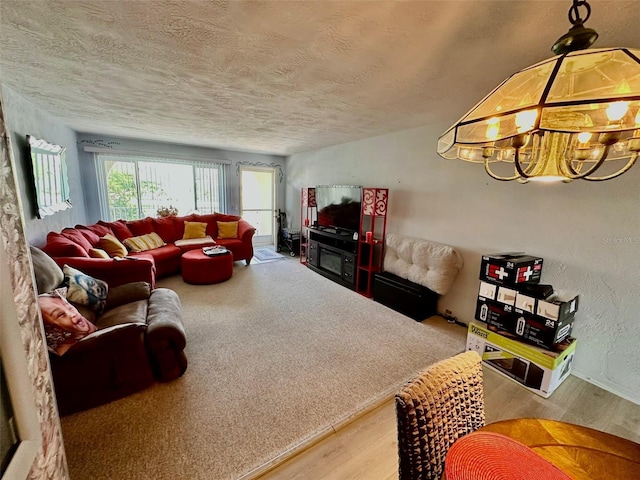 2434 Australia Way E Unit 38, Clearwater, FL 33763 - living room featuring wood finished floors, a textured ceiling, and a chandelier