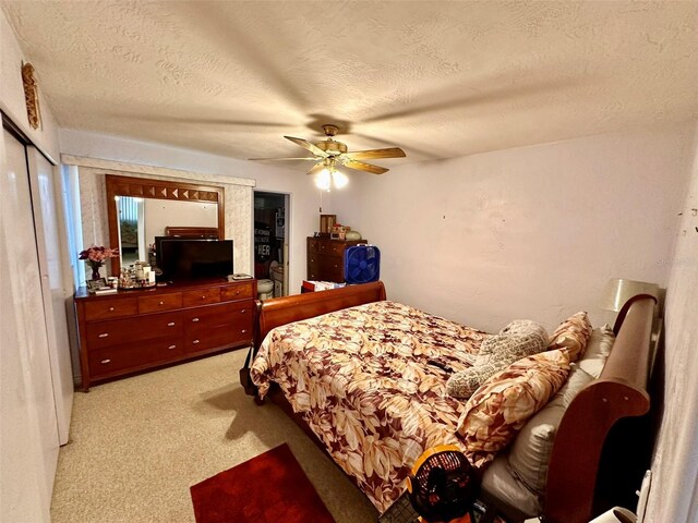 2434 Australia Way E Unit 38, Clearwater, FL 33763 - bedroom with light carpet, a textured ceiling, a ceiling fan, and a closet