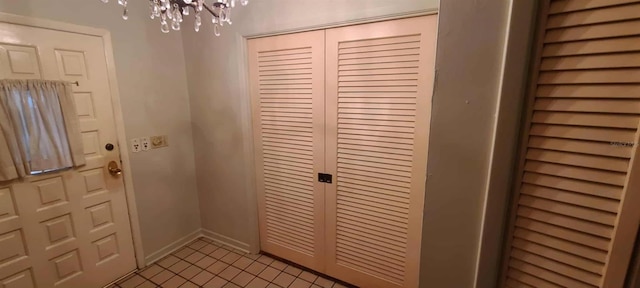 3717 Mckay Creek Dr, Largo, FL 33770 - foyer featuring a chandelier, light tile patterned floors, and baseboards