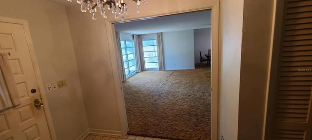 3717 Mckay Creek Dr, Largo, FL 33770 - hall with a chandelier, light colored carpet, and baseboards
