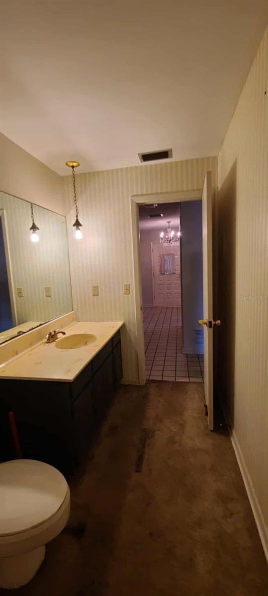 3717 Mckay Creek Dr, Largo, FL 33770 - bathroom featuring vanity, wallpapered walls, and toilet