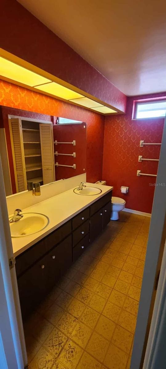3717 Mckay Creek Dr, Largo, FL 33770 - bathroom with double vanity, tile patterned floors, toilet, and a closet