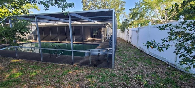 3717 Mckay Creek Dr, Largo, FL 33770 - back of house with a fenced backyard and glass enclosure