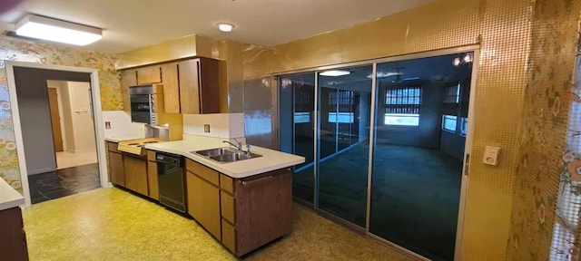 3717 Mckay Creek Dr, Largo, FL 33770 - kitchen featuring black dishwasher, a sink, light countertops, stovetop, and brown cabinets