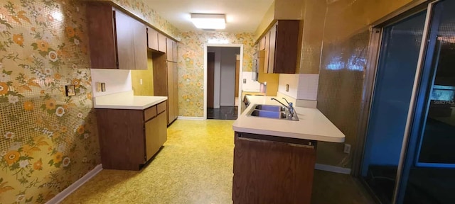 3717 Mckay Creek Dr, Largo, FL 33770 - kitchen with a sink, wallpapered walls, light countertops, baseboards, and paneled built in refrigerator