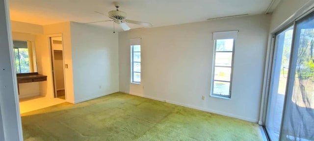 3717 Mckay Creek Dr, Largo, FL 33770 - unfurnished bedroom featuring multiple windows, light colored carpet, and baseboards