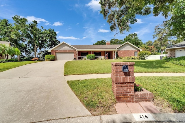 414 Summit Chase Dr, Valrico, FL 33594 - ranch-style home featuring a garage, a front yard, brick siding, concrete driveway, and a chimney