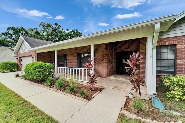 414 Summit Chase Dr, Valrico, FL 33594 - property entrance with covered porch, brick siding, and an attached garage