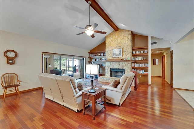 414 Summit Chase Dr, Valrico, FL 33594 - living room with light wood-style floors, ceiling fan, baseboards, and a stone fireplace