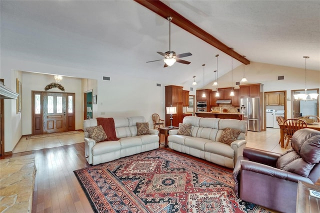 414 Summit Chase Dr, Valrico, FL 33594 - living room with a ceiling fan, a chandelier, washer and clothes dryer, and light wood-style flooring
