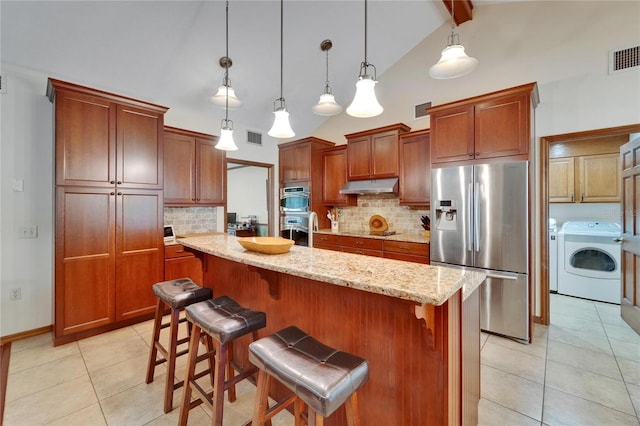 414 Summit Chase Dr, Valrico, FL 33594 - kitchen featuring appliances with stainless steel finishes, under cabinet range hood, light tile patterned flooring, tasteful backsplash, and a center island