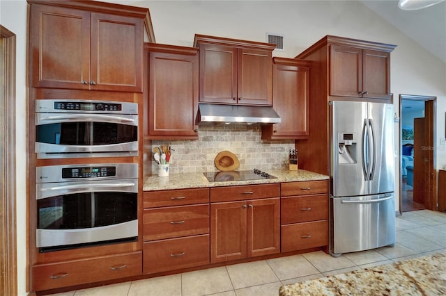 414 Summit Chase Dr, Valrico, FL 33594 - kitchen with appliances with stainless steel finishes, under cabinet range hood, decorative backsplash, light stone counters, and lofted ceiling