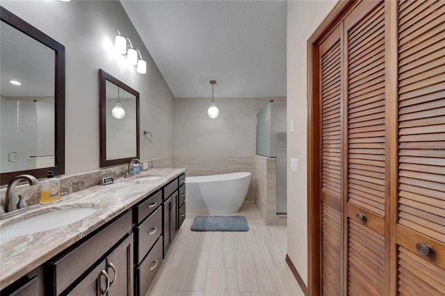 414 Summit Chase Dr, Valrico, FL 33594 - full bath featuring a closet, double vanity, a freestanding bath, tile walls, and a shower with shower door