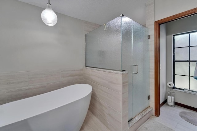 414 Summit Chase Dr, Valrico, FL 33594 - full bath featuring a soaking tub, a shower stall, healthy amount of natural light, and tile walls