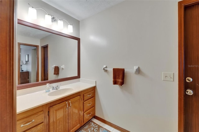 414 Summit Chase Dr, Valrico, FL 33594 - bathroom featuring vanity, tile patterned flooring, a textured ceiling, and baseboards