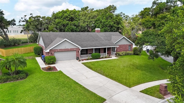 414 Summit Chase Dr, Valrico, FL 33594 - ranch-style home with a porch, brick siding, a garage, a front lawn, and driveway