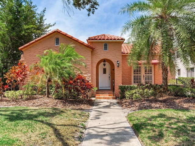 4521 W Azeele St, Tampa, FL 33609 - mediterranean / spanish house with a tiled roof, stucco siding, and a front yard