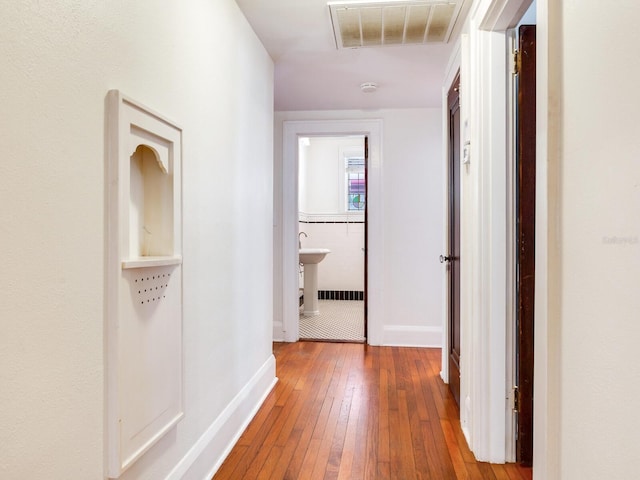 4521 W Azeele St, Tampa, FL 33609 - hallway featuring hardwood / wood-style floors and baseboards