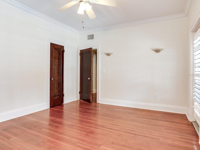 4521 W Azeele St, Tampa, FL 33609 - empty room featuring light wood finished floors, crown molding, a ceiling fan, and baseboards