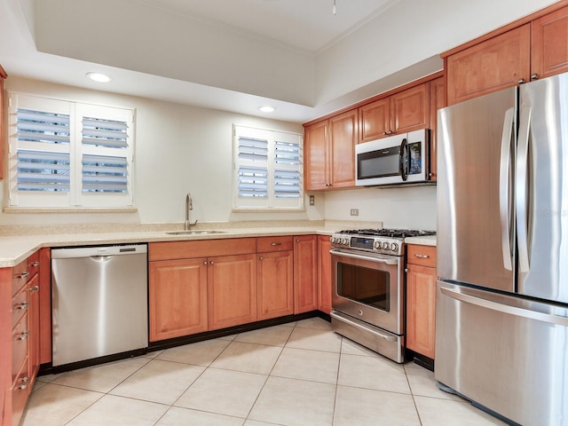 4521 W Azeele St, Tampa, FL 33609 - kitchen featuring appliances with stainless steel finishes, a sink, light countertops, recessed lighting, and brown cabinets