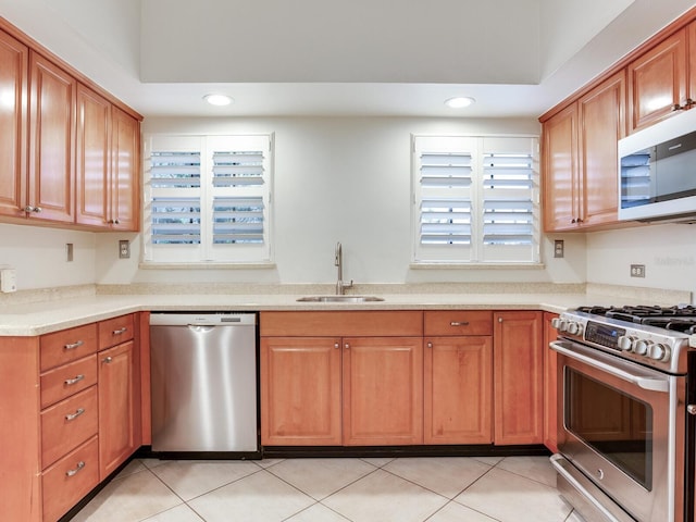 4521 W Azeele St, Tampa, FL 33609 - kitchen with stainless steel appliances, a sink, recessed lighting, light countertops, and light tile patterned floors